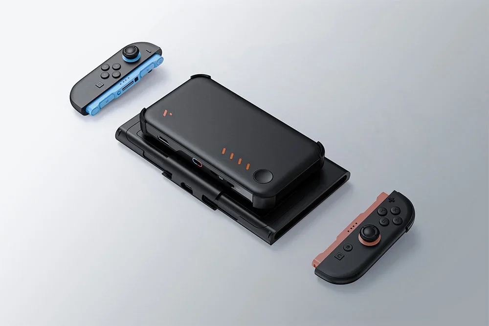 Black holder with attached powerbank and detached console controllers floats over bright surface